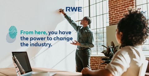 A person writes on a whiteboard in a bright office, with a quote about industry change visible. There is a leafy desk plant.
