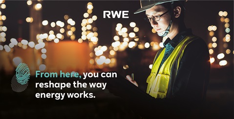 A worker in a safety vest stands at night, holding a clipboard in front of illuminated structures, promoting energy innovation.