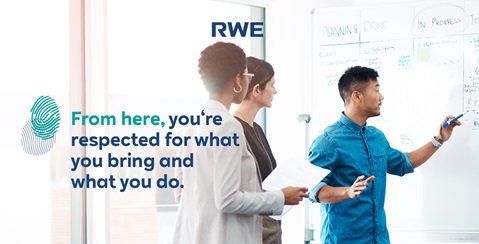 A group of professionals collaborate in a modern office space while discussing plans on a whiteboard.
