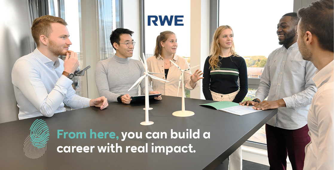 A group of diverse individuals discussing career opportunities at RWE, with wind turbine models and a presentation on a table.