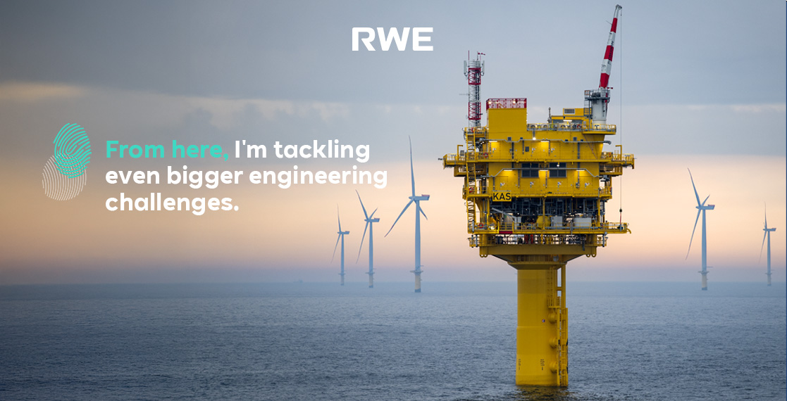 A yellow offshore platform stands in the sea, with wind turbines visible in the background.