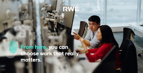 Two professionals collaborate at a desk in a modern office, with insights on meaningful work.