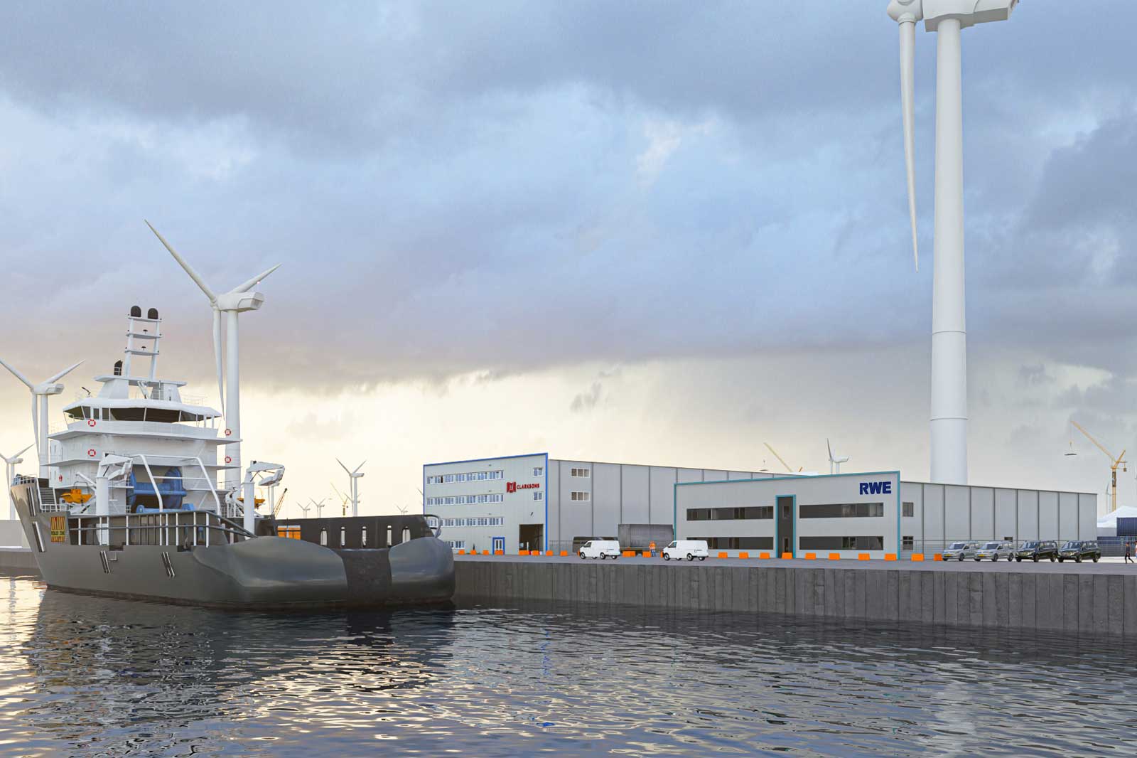 A ship is docked at a harbour with wind turbines and warehouses in the background. The water's surface reflects the surroundings.
