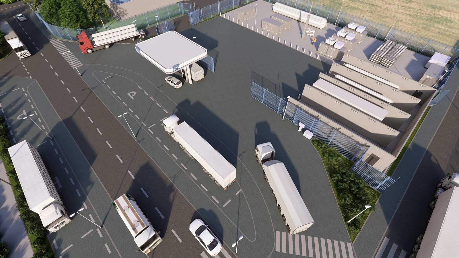 Aerial view of a truck parking area with a fuel station and storage facilities, surrounded by fences and roads.