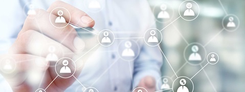 A hand interacting with a network of icons representing people and their connections.