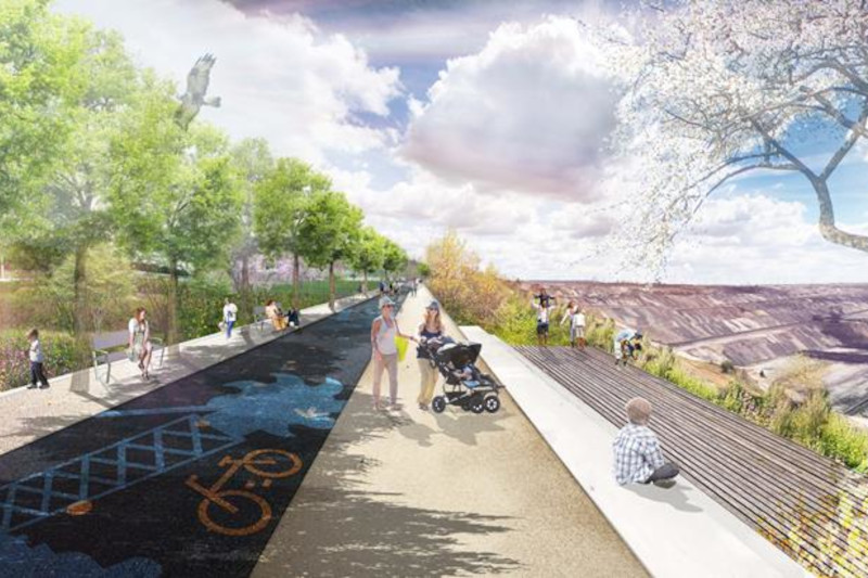 Ein lebhafter Parkweg mit Radfahrern und Fußgängern, gesäumt von Bäumen und mit Blick auf eine malerische Landschaft.