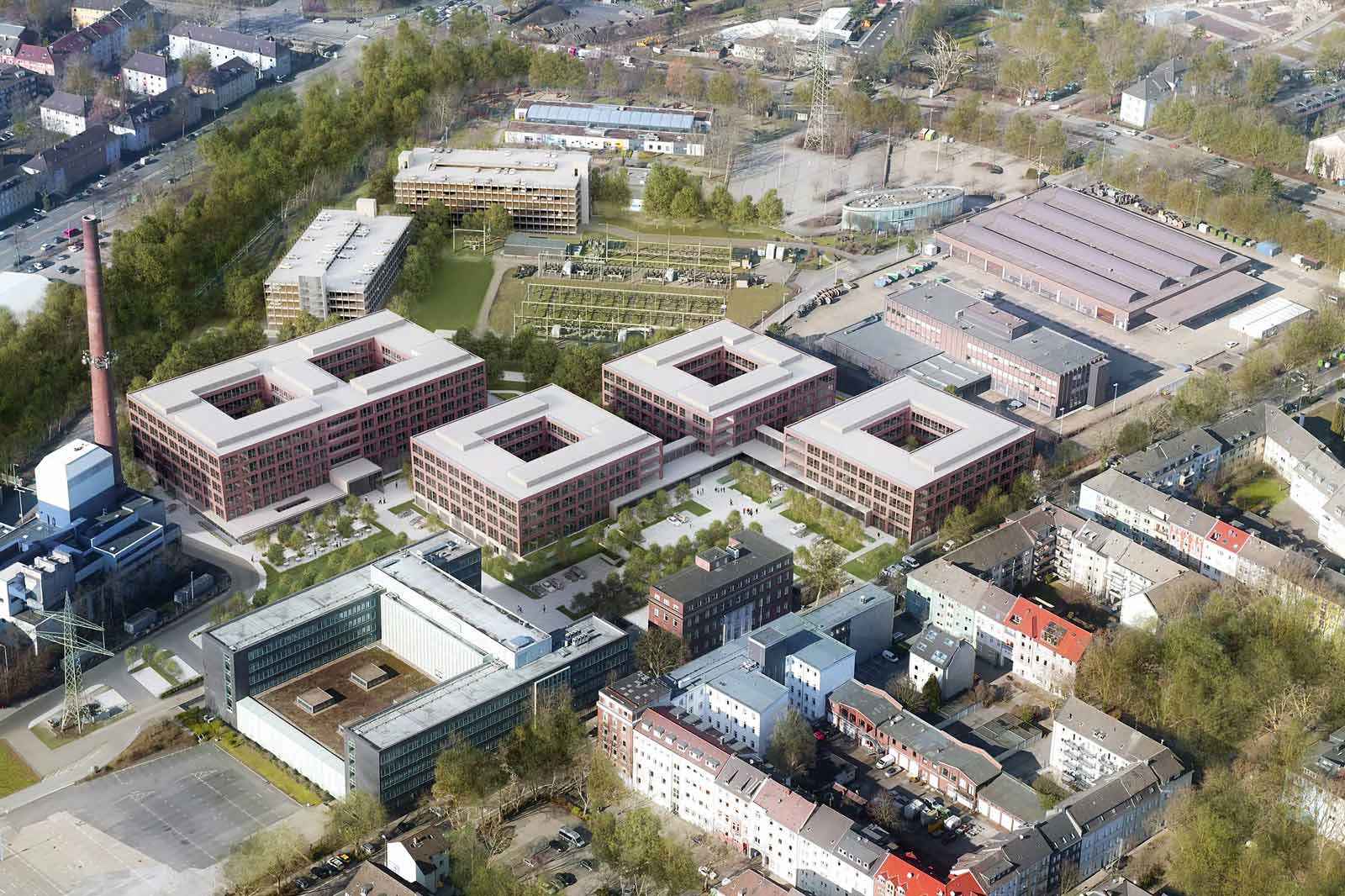 Aerial view of an urban area featuring modern buildings, green spaces, and surrounding trees.
