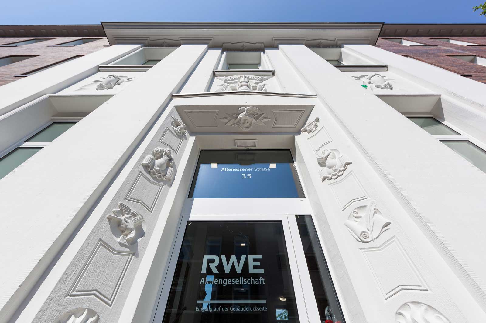 The facade of a historic building featuring ornate decorations and the entrance of RWE Aktiengesellschaft.