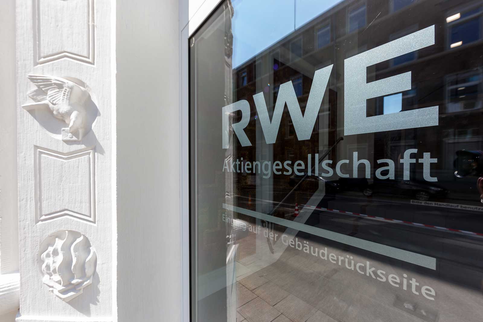 The façade displays the RWE logo on a glass window alongside an ornamental wall decoration.