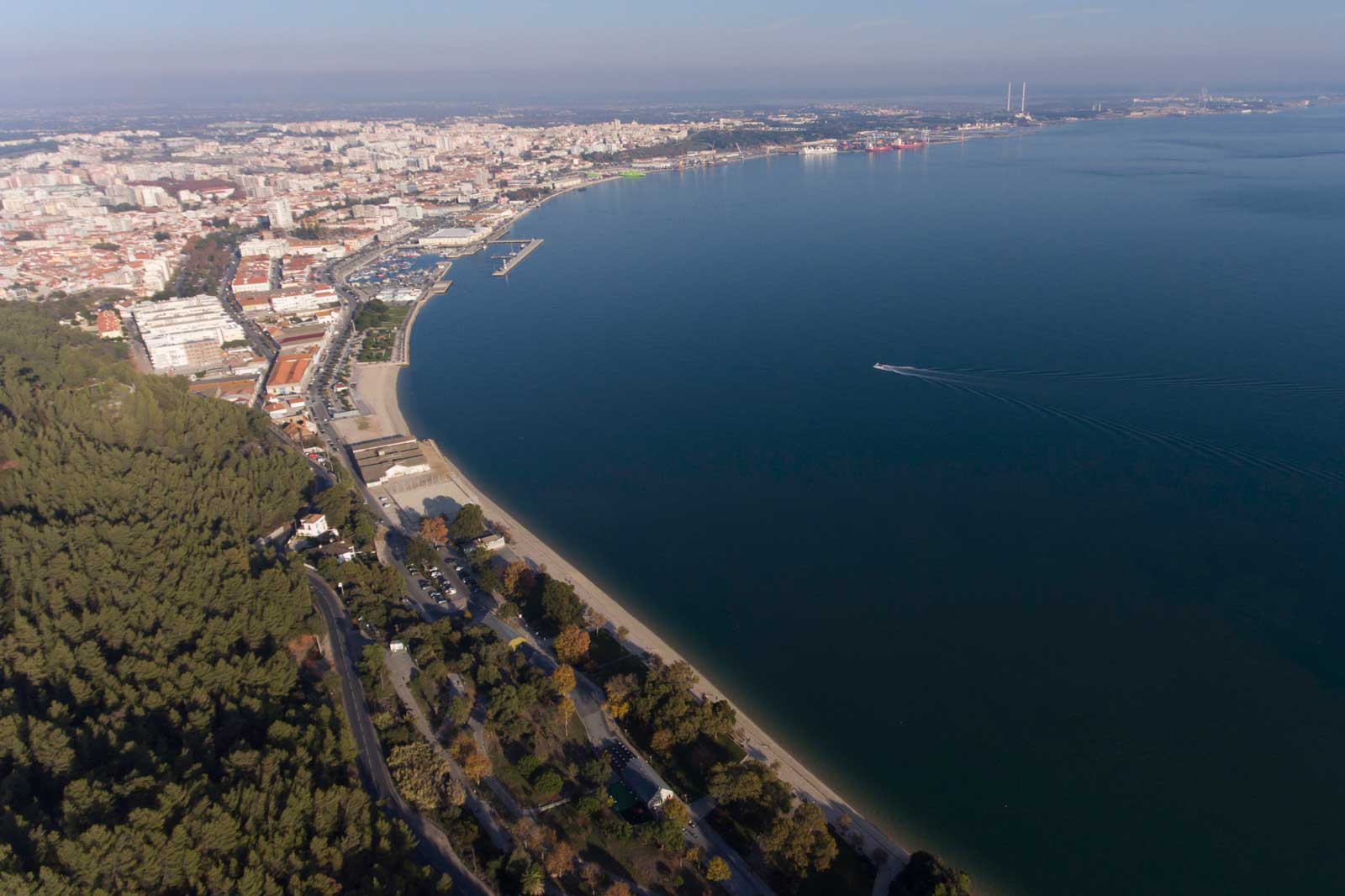 Aerial view of a coastal city with sandy beaches and clear blue water.