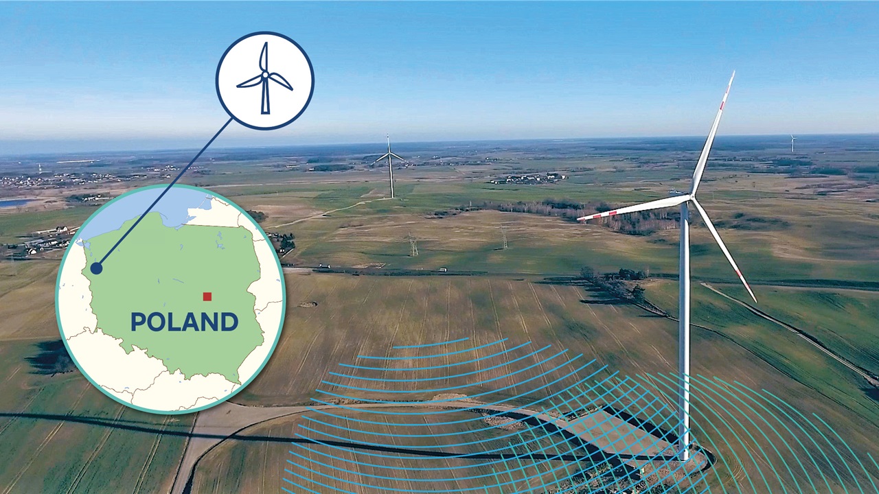 A wind turbine in Poland, surrounded by fields and under a blue sky, with a map marker.