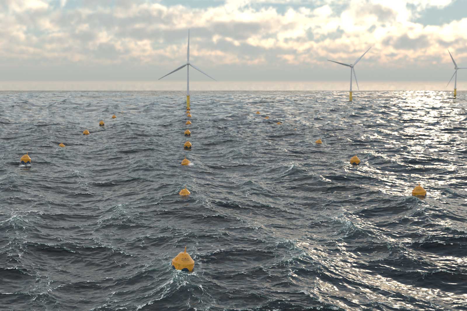 A view of wind turbines and yellow buoys on the water, under a cloudy sky.
