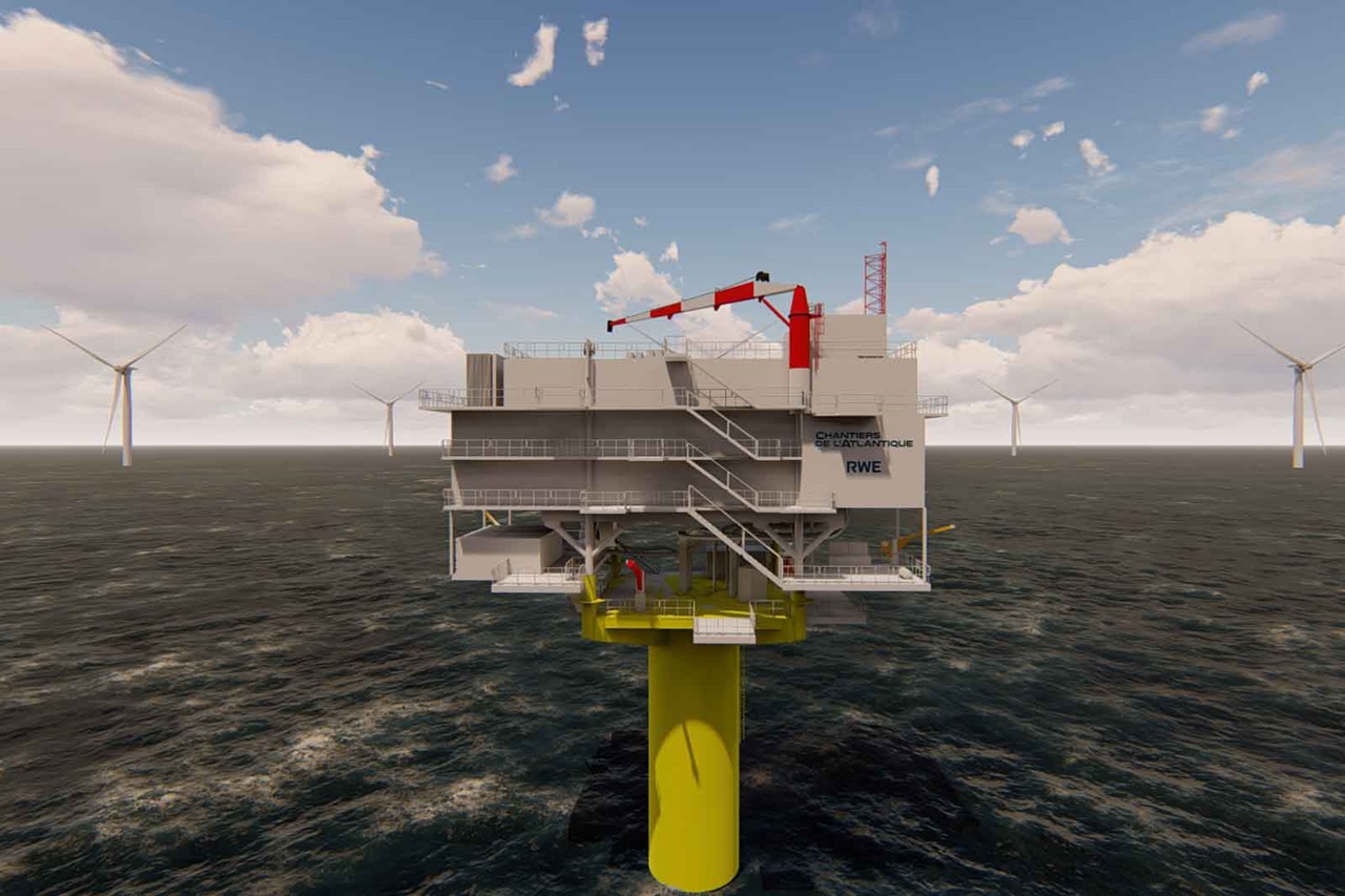 Eine Offshore-Anlage mit einem gelben Fundament und mehreren Windkraftanlagen im Hintergrund. Es ist bewölkt.