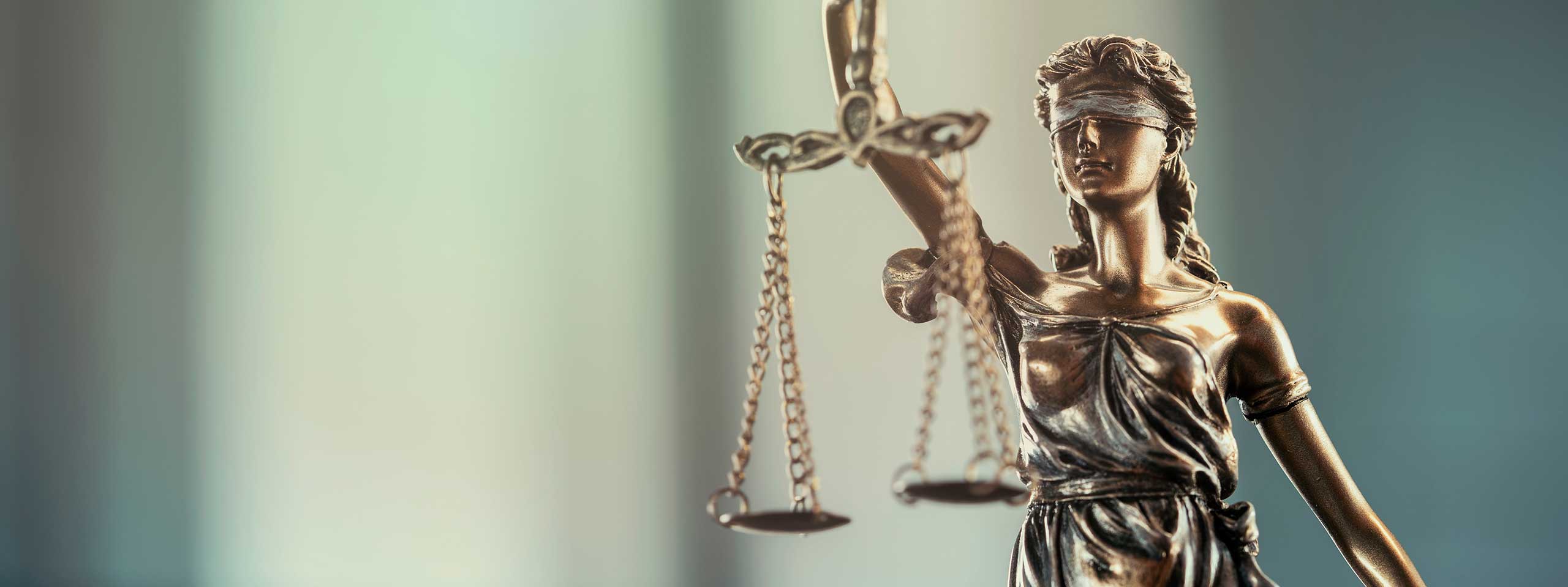 A statue of Lady Justice holding scales, symbolising justice and the rule of law.