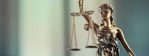 A statue of Lady Justice holding scales, symbolising justice and the rule of law.