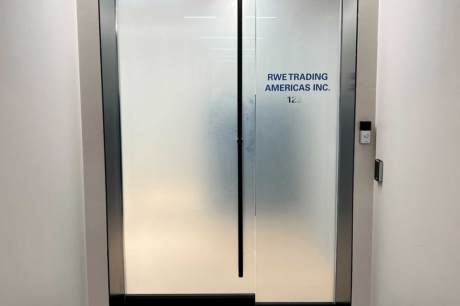 The glass door displays the company name RWE Trading Americas Inc. and the number 123.