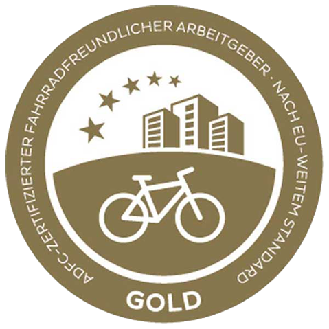 Gold award for bicycle-friendly employers, featuring a bicycle, buildings, and stars.