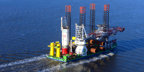 Installation vessel carries foundation pieces out to sea